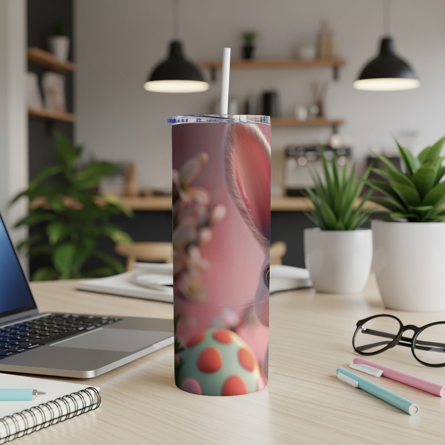 Easter bunny tumbler with decorative eggs and spring flowers on a desk.