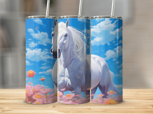 White horse in a field of pink flowers under a blue sky with clouds.