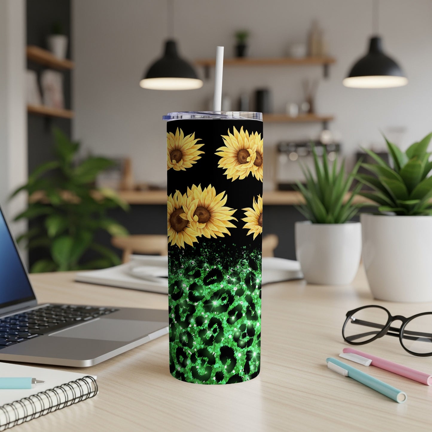 Green leopard print tumbler with sunflowers and a white straw.