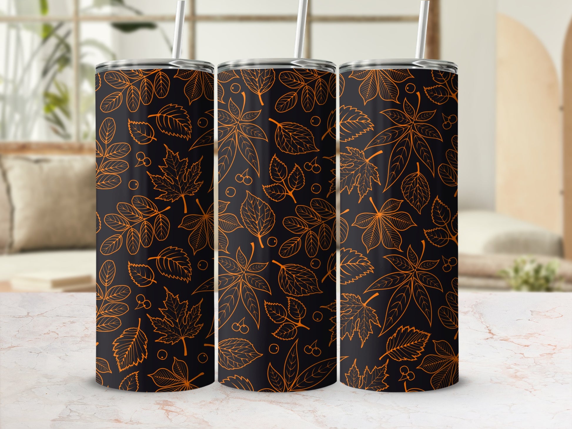 Three tumblers with an orange leaf and cherry pattern on a dark background.