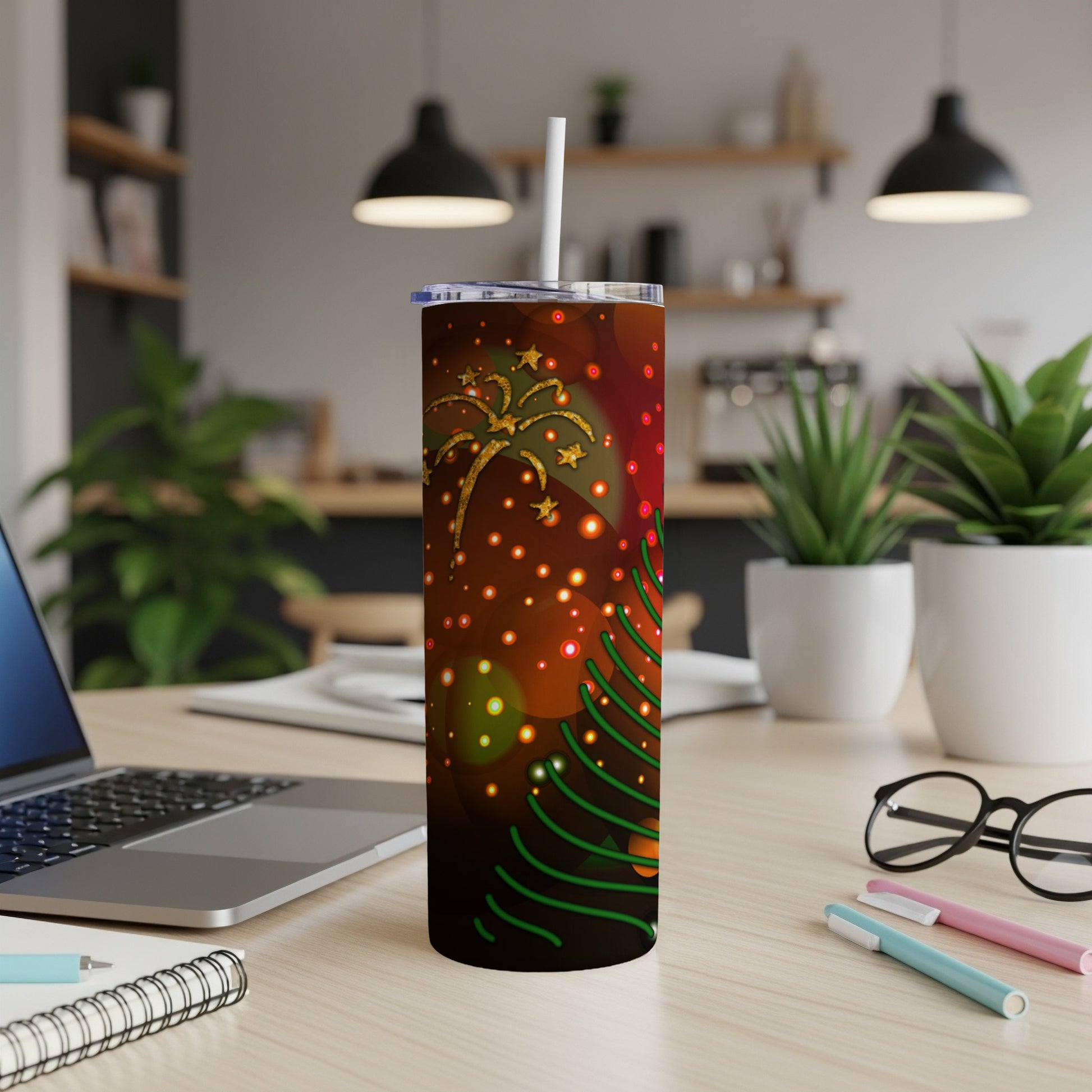 Christmas tree and fireworks design on a tumbler with a straw.
