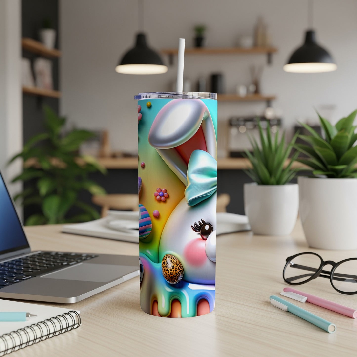 Easter bunny tumbler with colorful eggs and bow on a desk.
