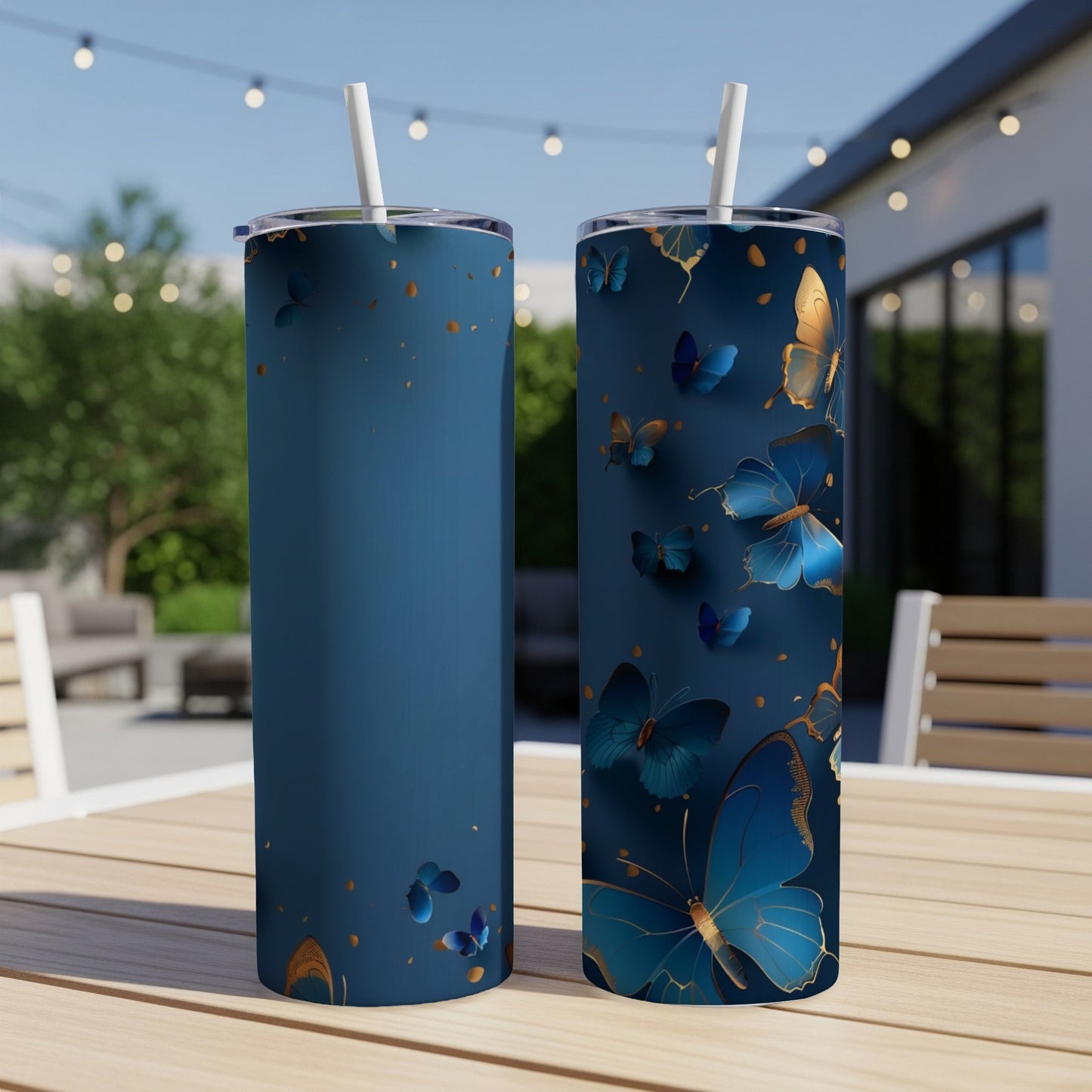 Two navy blue tumblers with gold and blue butterflies.