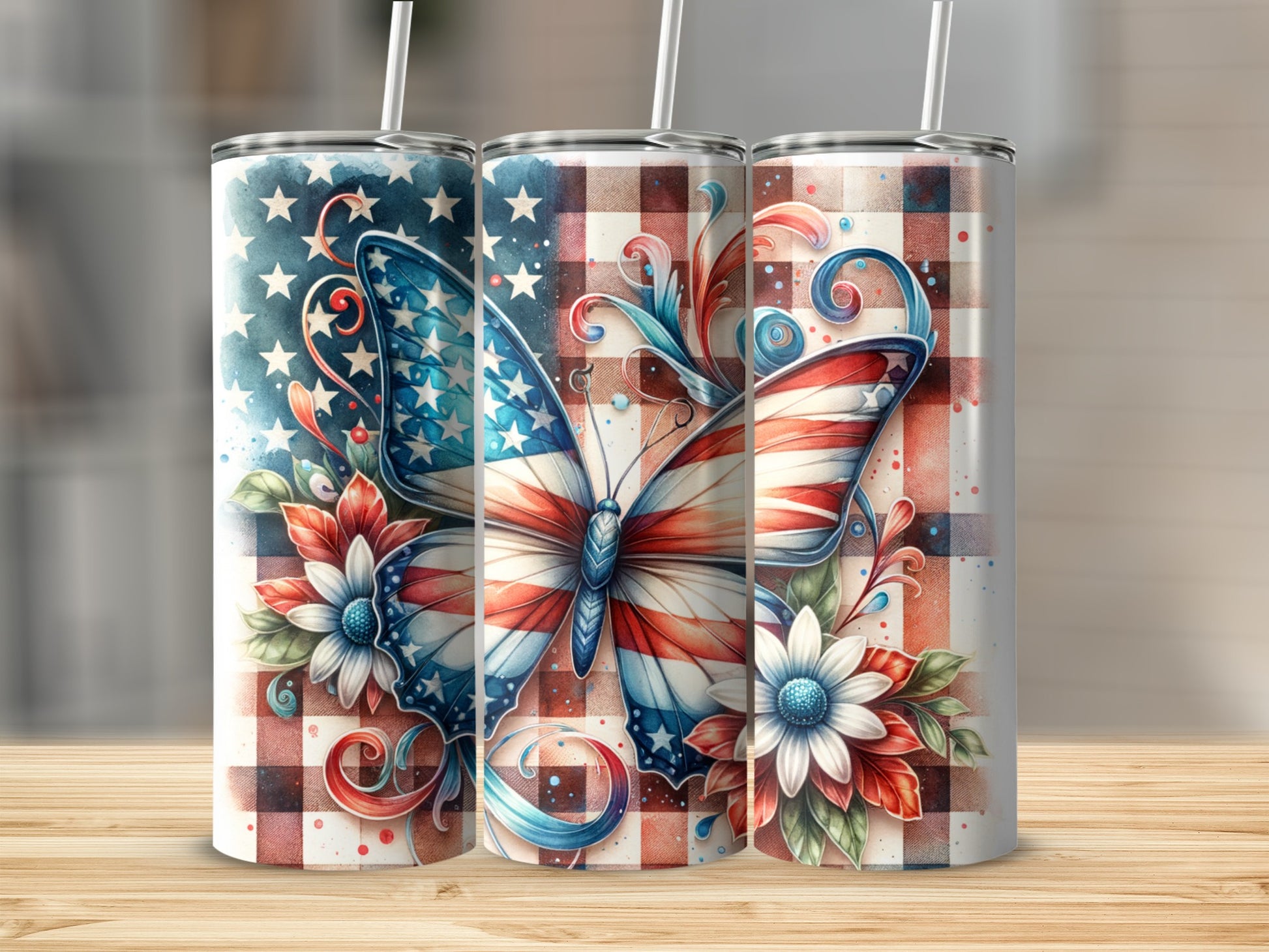 Three tumblers with patriotic butterfly and floral designs on plaid background.