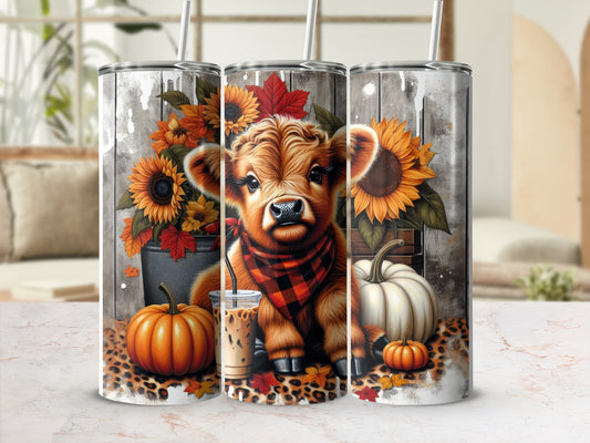 Cow with sunflowers, pumpkins, and leopard print accents on a tumbler.