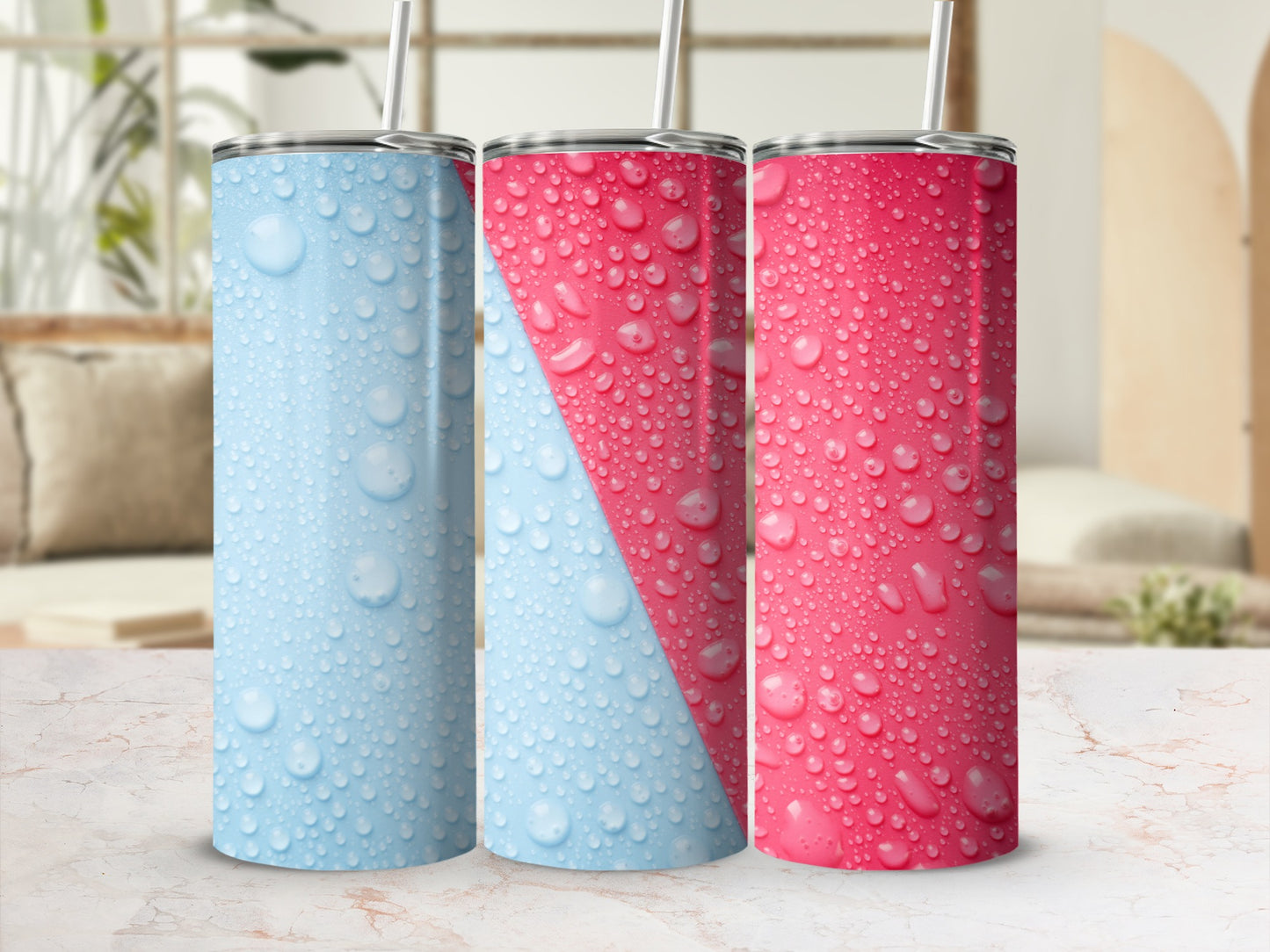 Three stainless steel tumblers with condensation and a pink and blue diagonal stripe design.