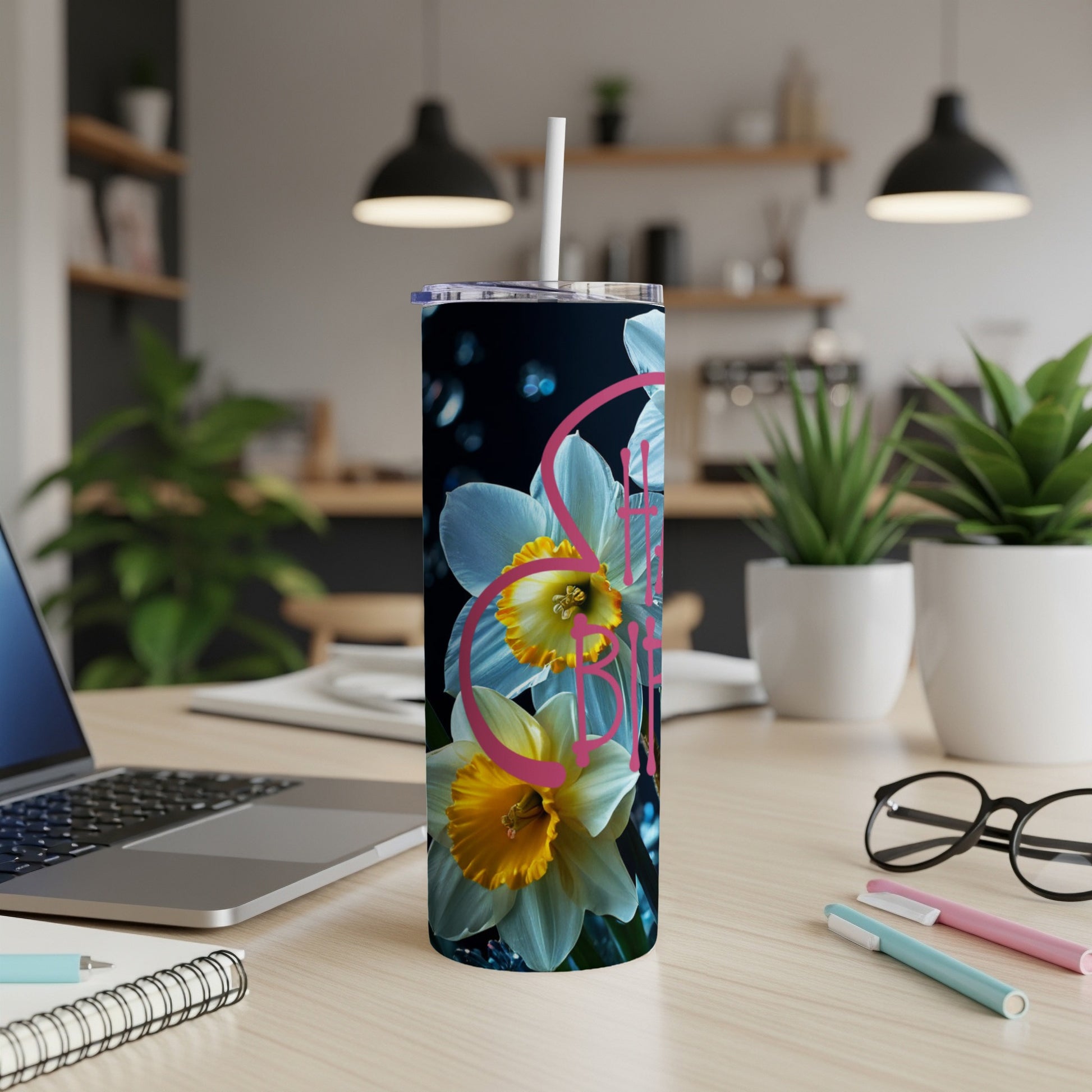 White tumbler with yellow and pink daffodils and the word "Spring".