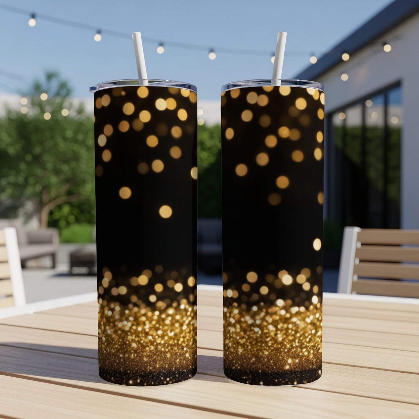 Two tall tumblers with a bokeh glitter design on a table.