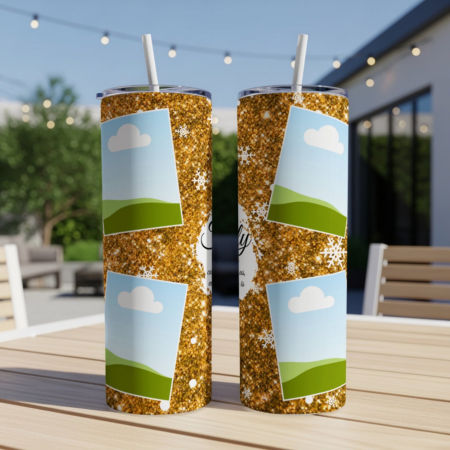 Two gold glitter tumblers with cloud, hill, and snowflake designs.