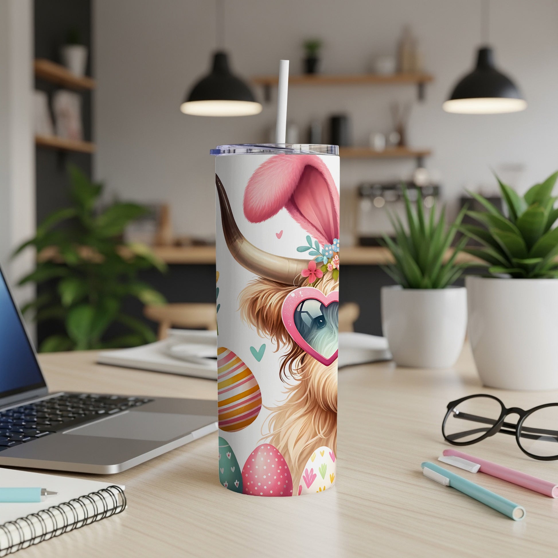 Highland cow wearing bunny ears and heart sunglasses, with Easter eggs on a tumbler.