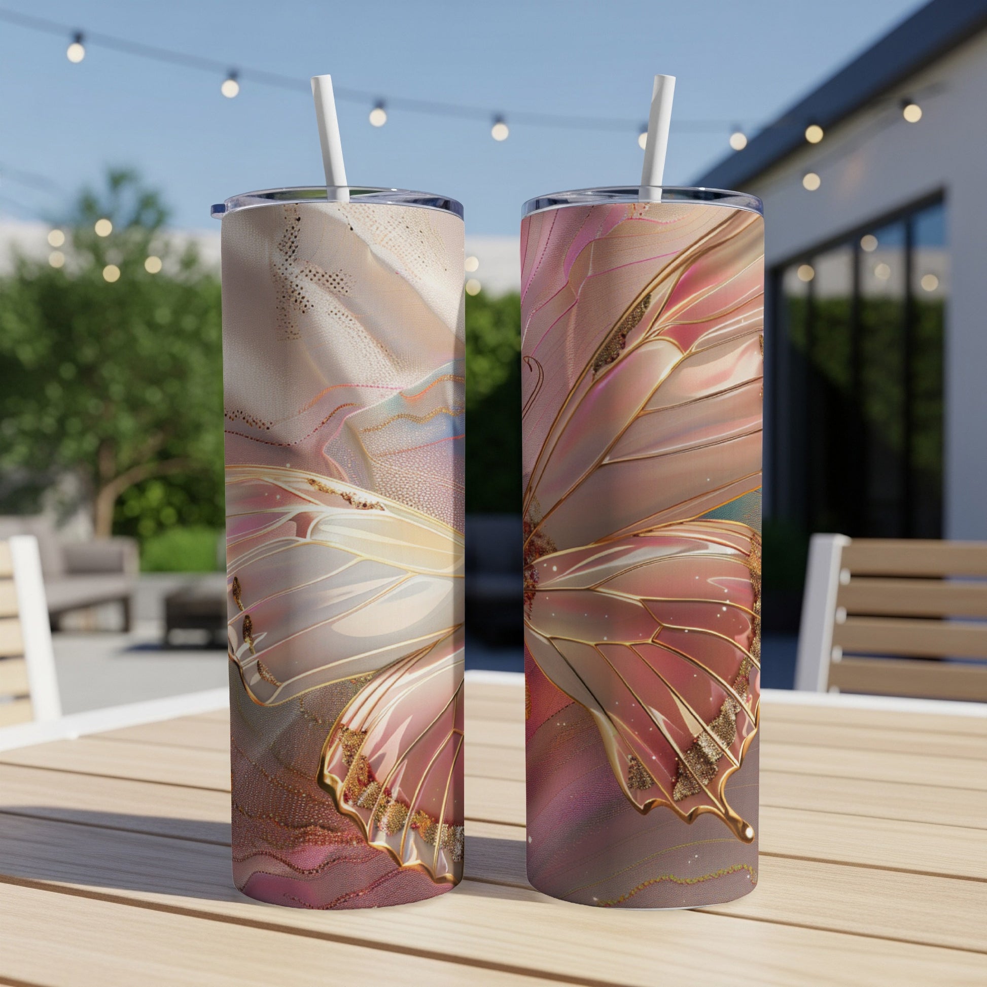 Two rose gold and pearl butterfly tumblers on a wooden table.