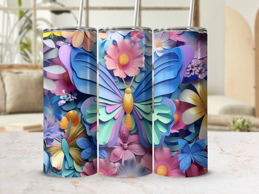 Three tumblers with butterfly and floral designs on a marble surface.