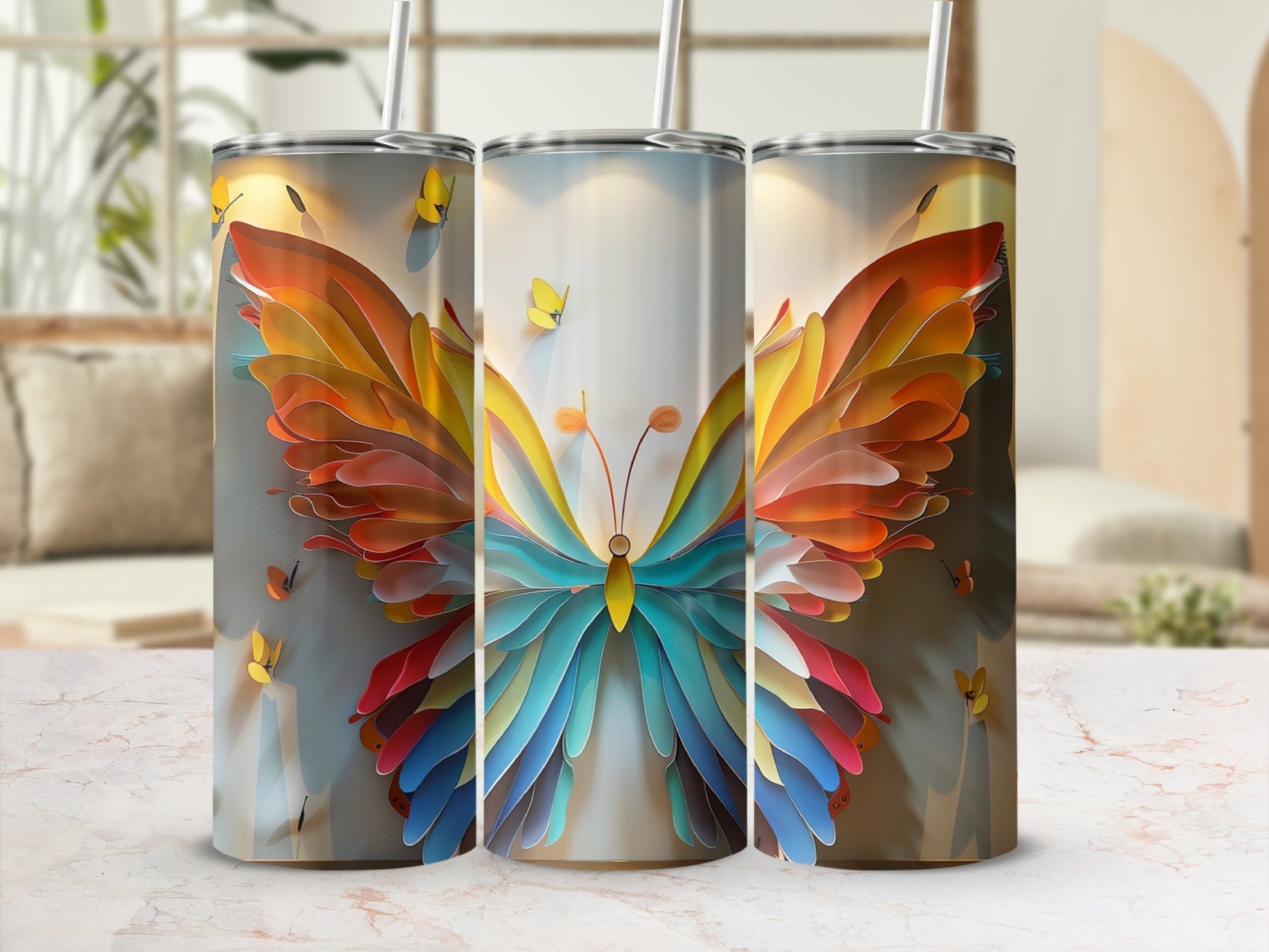 Three tumblers with colorful butterfly wing designs, two straws visible.