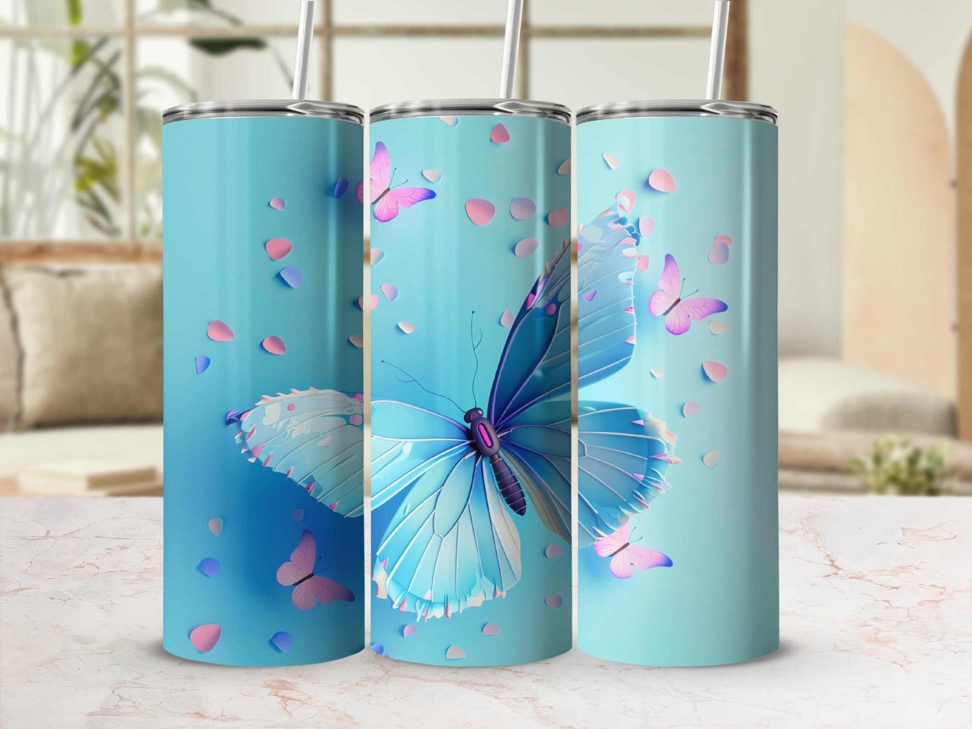 Three blue tumblers with a large blue butterfly and pink petals design.