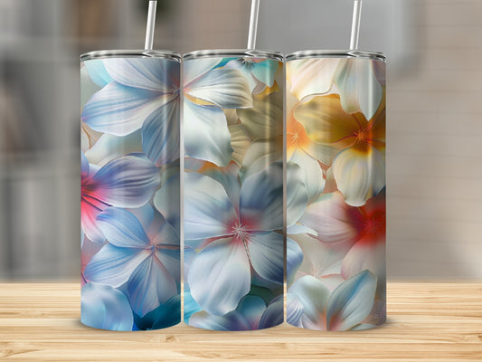 Three tumblers with colorful floral patterns on a wooden surface.