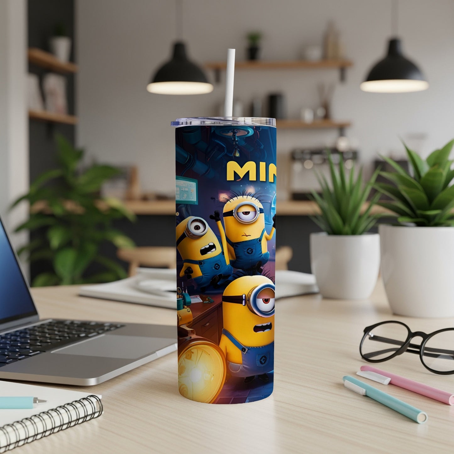 Minions Stuart, Bob, and Kevin on a blue tumbler with white lid and straw.