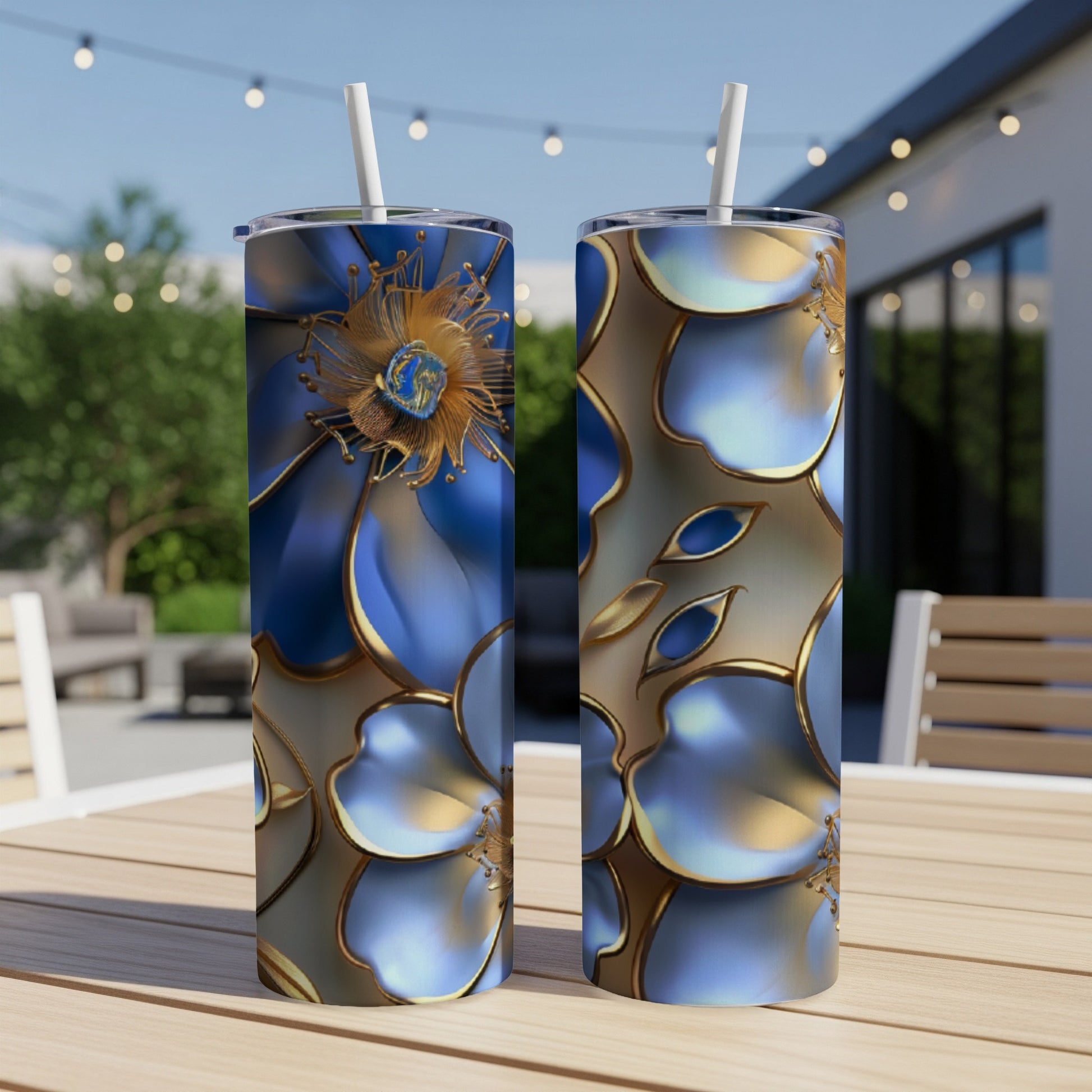Two tumblers with blue and gold floral abstract design on a wooden table.