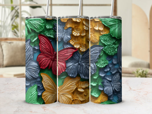 Three tumblers with a raised butterfly and floral design in green, gold, and blue.