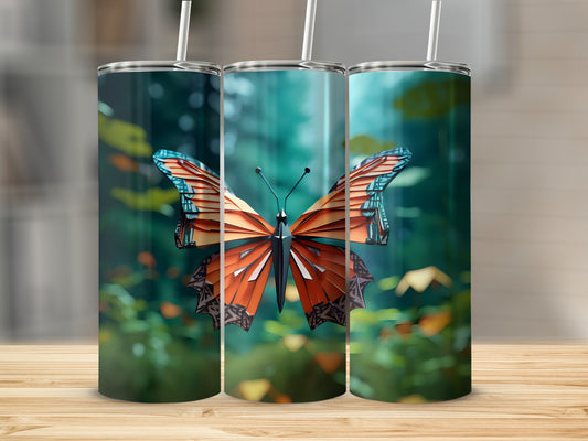 Three tumblers with an orange and blue butterfly design on a blurred background.