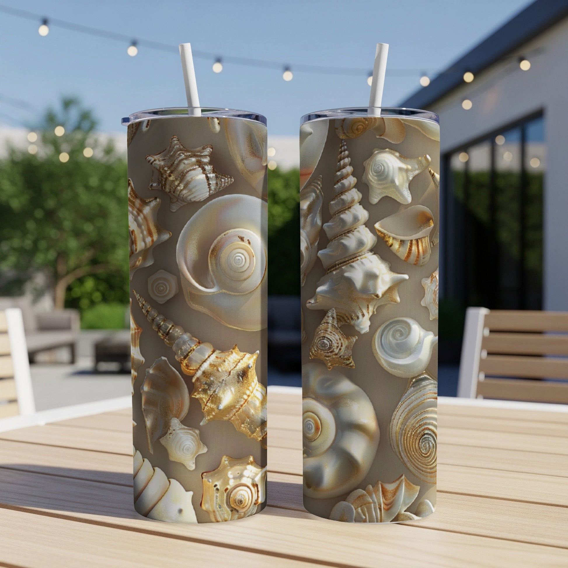 Two tall tumblers with a realistic seashell pattern sit on a table.