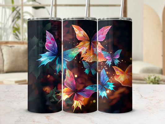 Three tumblers with colorful geometric butterflies on a dark, bokeh background.