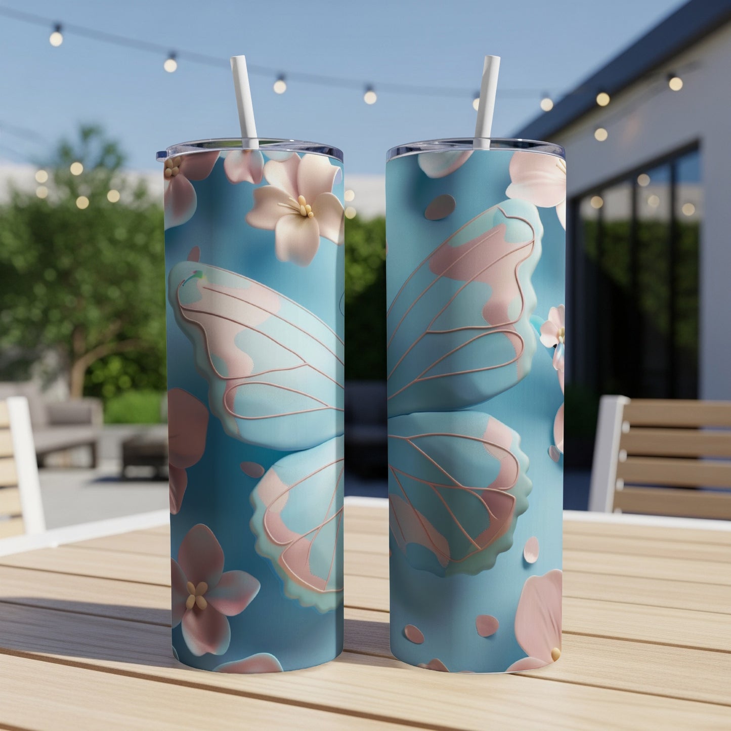 Two blue tumblers with pink butterfly wings and floral designs.