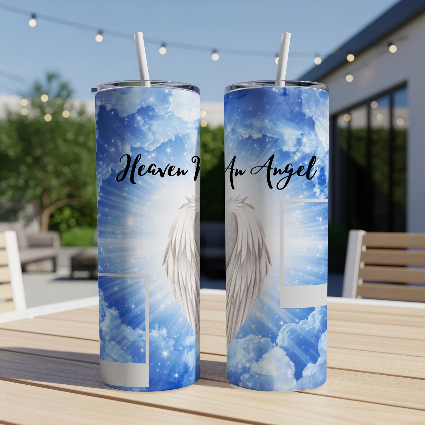 Two tumblers with a celestial blue sky, clouds, stars, and angel wings design.
