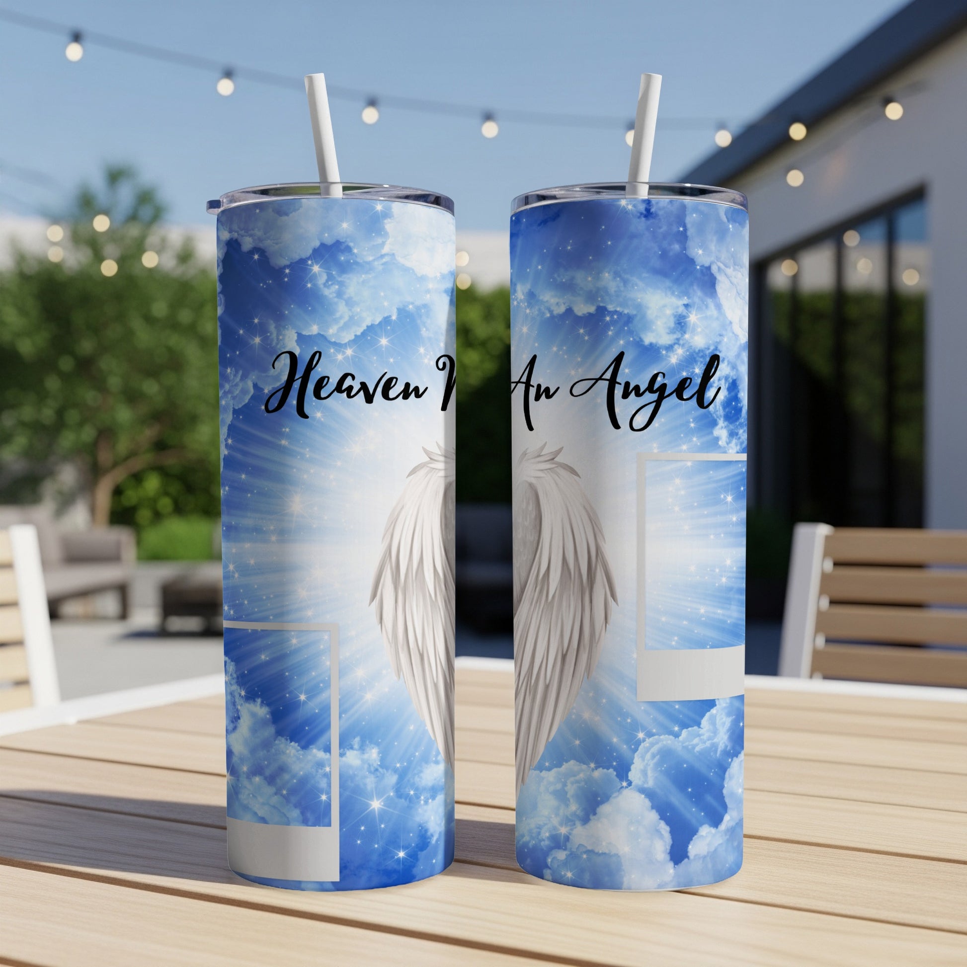 Two tumblers with a celestial blue sky, clouds, stars, and angel wings design.