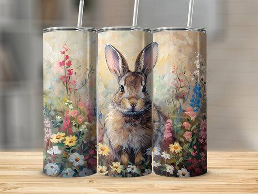 Three tumblers featuring a close-up painting of a bunny in a field of flowers.