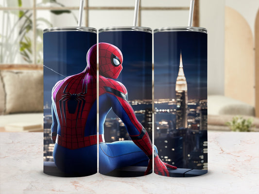 Spiderman sitting on a rooftop overlooking a city skyline.