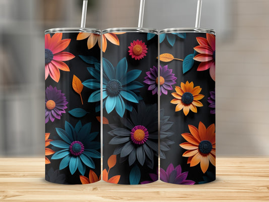 Three tumblers with vibrant floral patterns on a wooden surface.