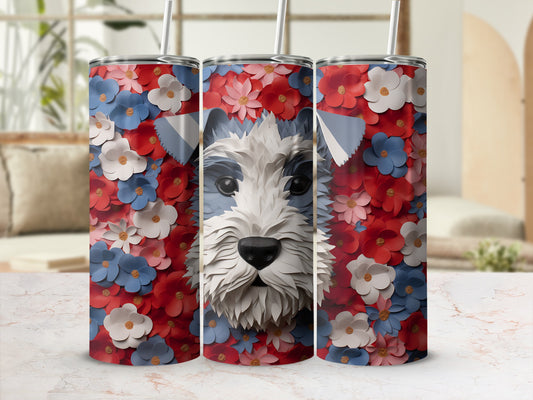 Schnauzer dog face surrounded by red and blue flowers on a patterned tumbler.