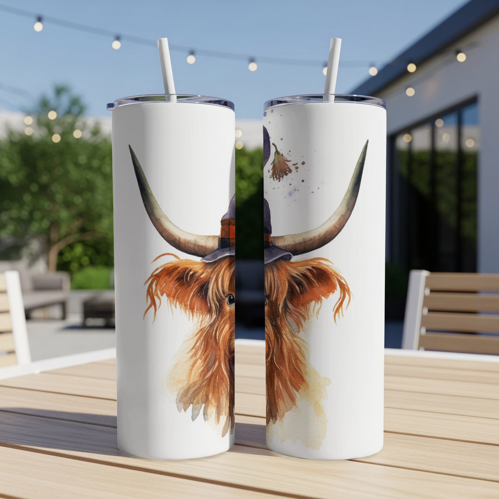 Watercolor Highland cow wearing witch hat, depicted on two skinny tumblers.