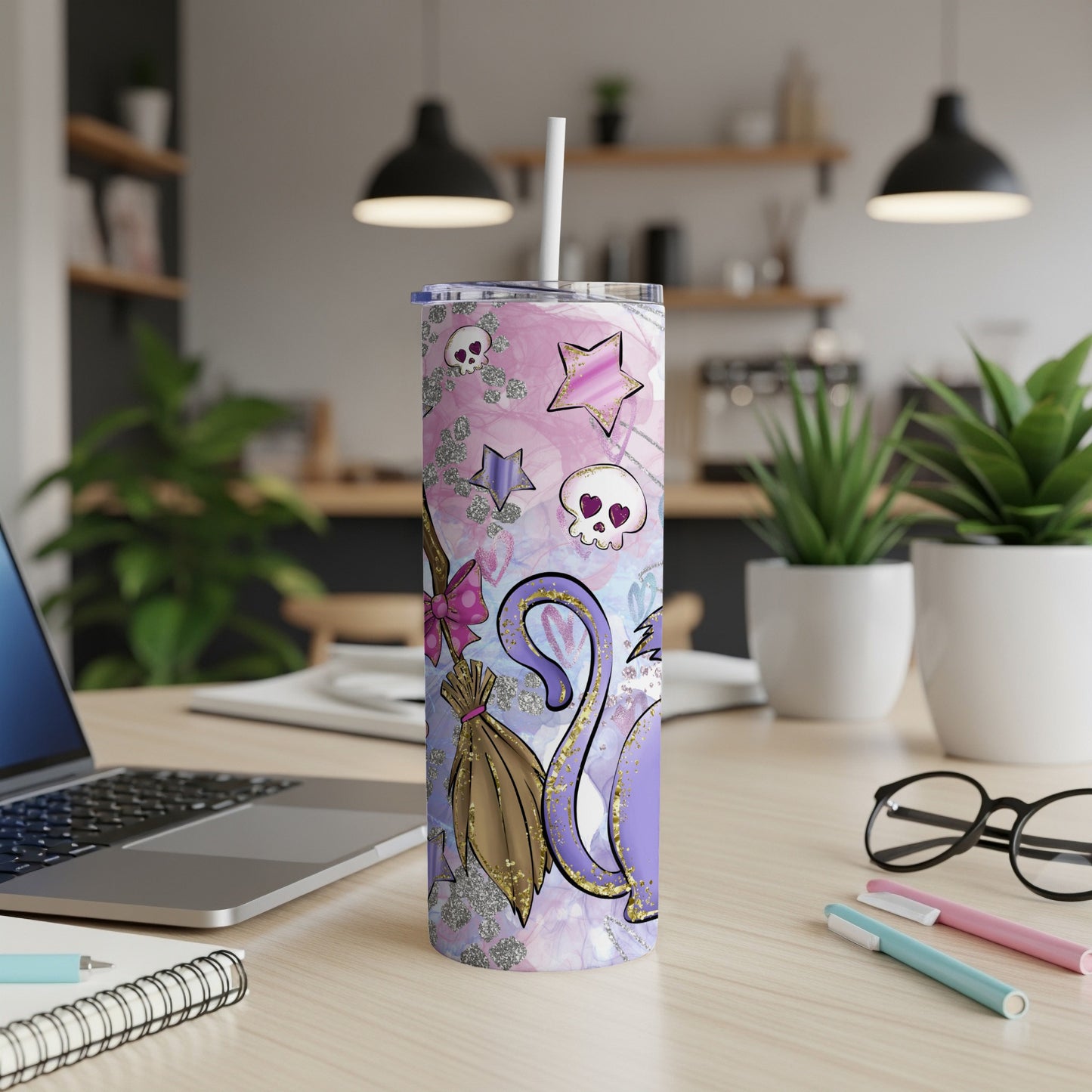Purple and pink cat tumbler with stars, skulls, and broomstick.