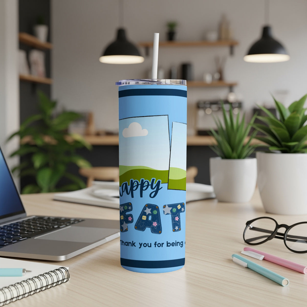Blue tumbler with "Happy FAT" and "thank you for being" text on a desk.