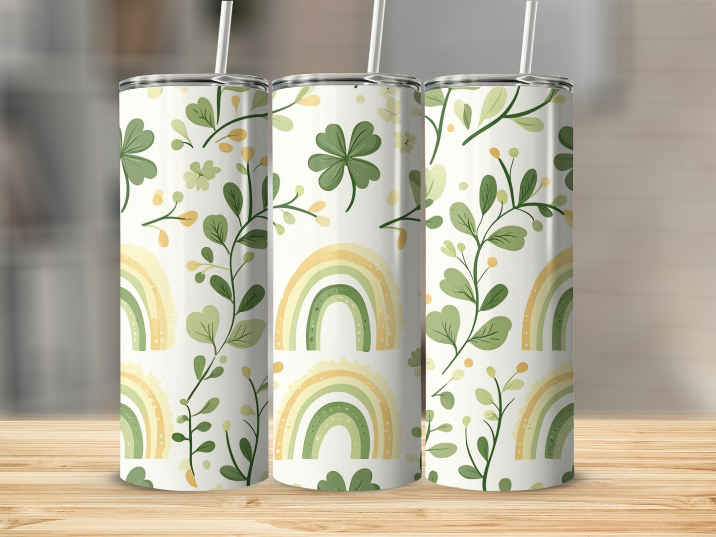 Rainbows and shamrocks pattern on three insulated tumblers.