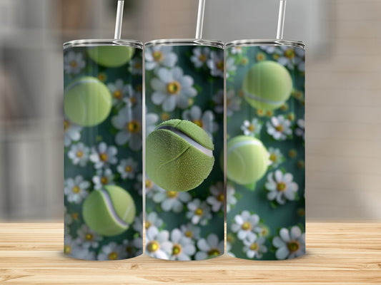 Three tumblers with tennis balls and daisies, set on a wooden surface.