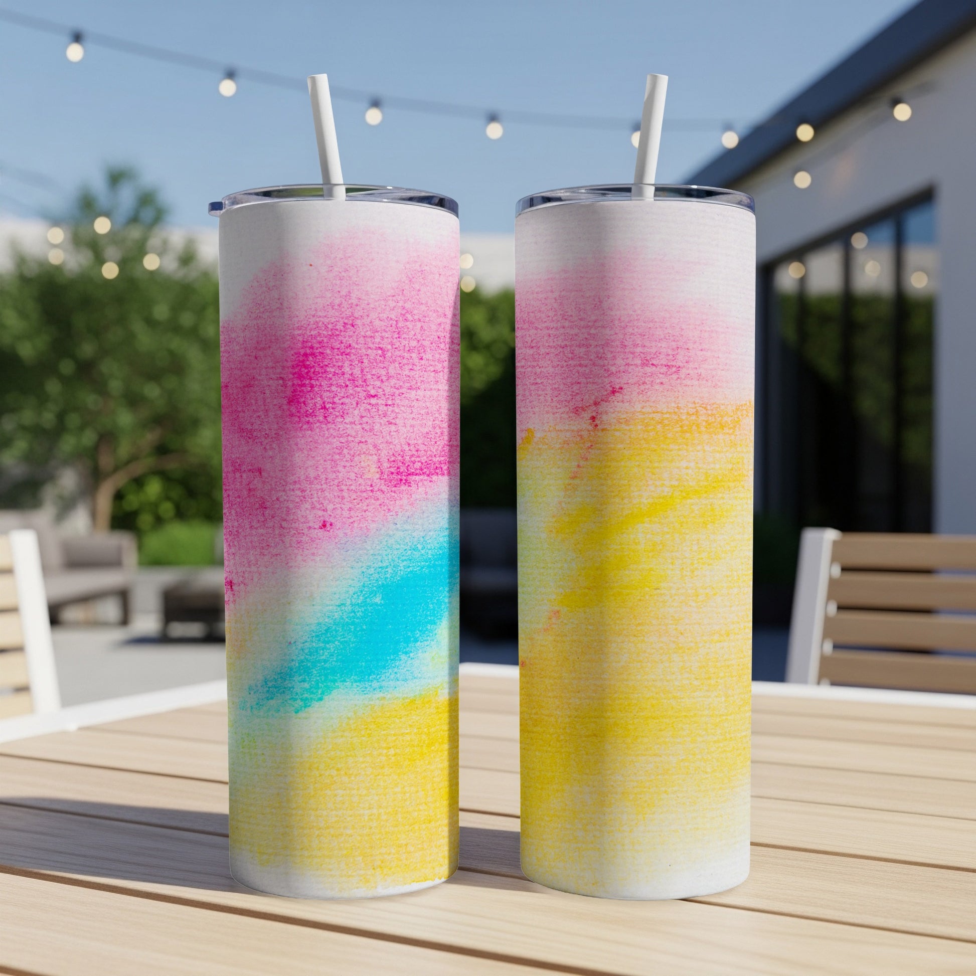 Two tall tumblers with a watercolor abstract design of pink, blue, and yellow.