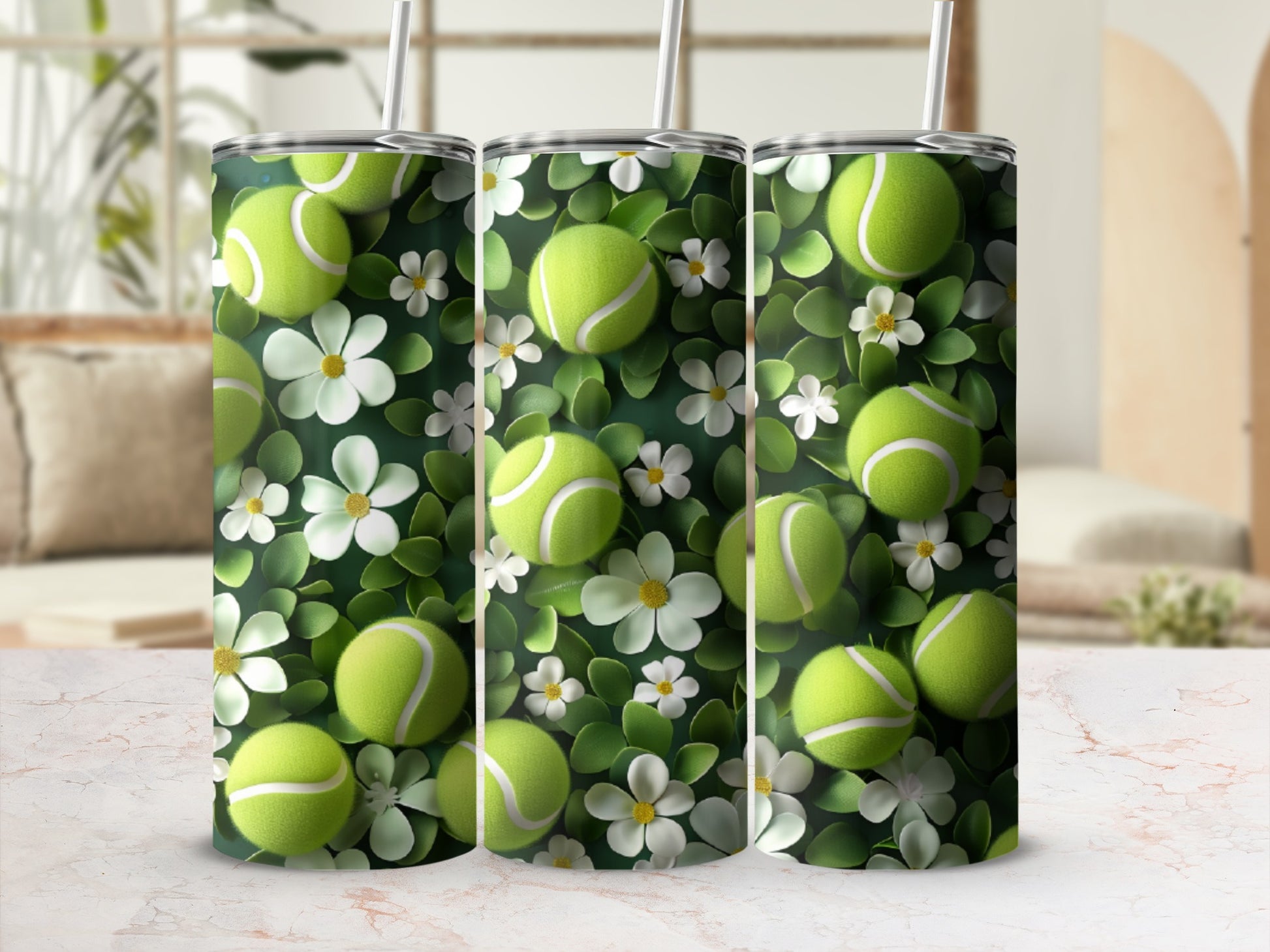Three tumblers with tennis balls and white flowers on a blurred background.
