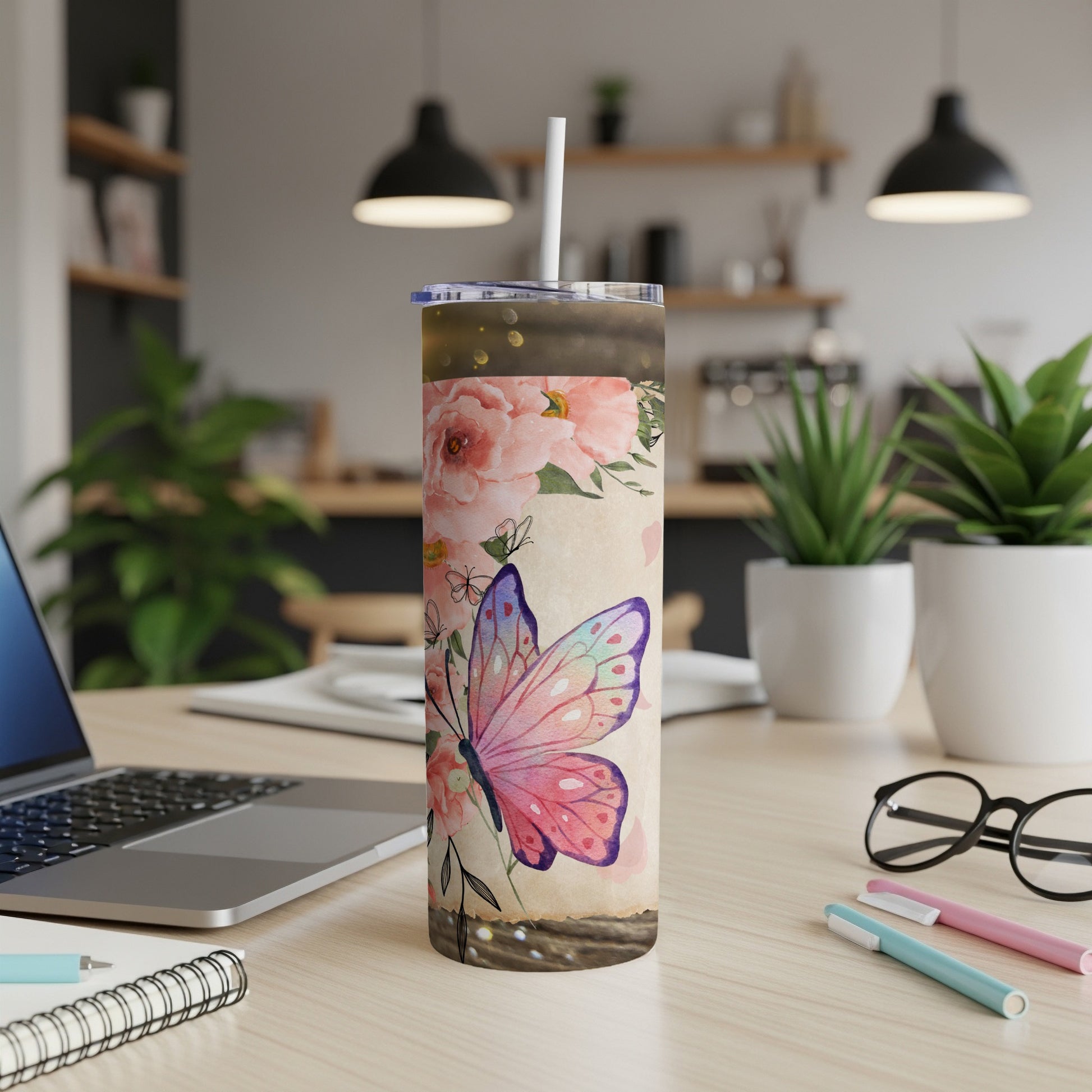 Tumbler with pink roses and a watercolor butterfly design and straw.