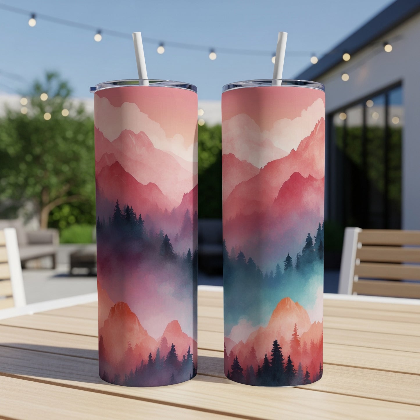 Two tumblers with a pink and blue mountain and forest design.