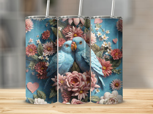 Two blue lovebirds nestled among pink and white flowers on a blue background.
