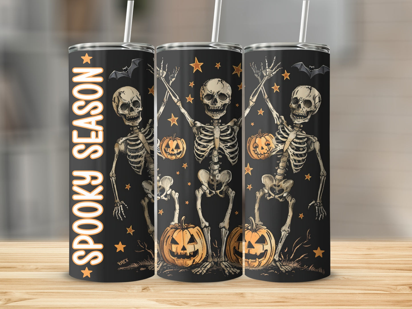 Black tumbler with skeletons, pumpkins, bats, and "Spooky Season" text.