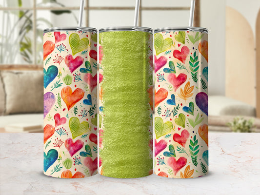 Three tumblers with colorful heart patterns and a textured green center tumbler.