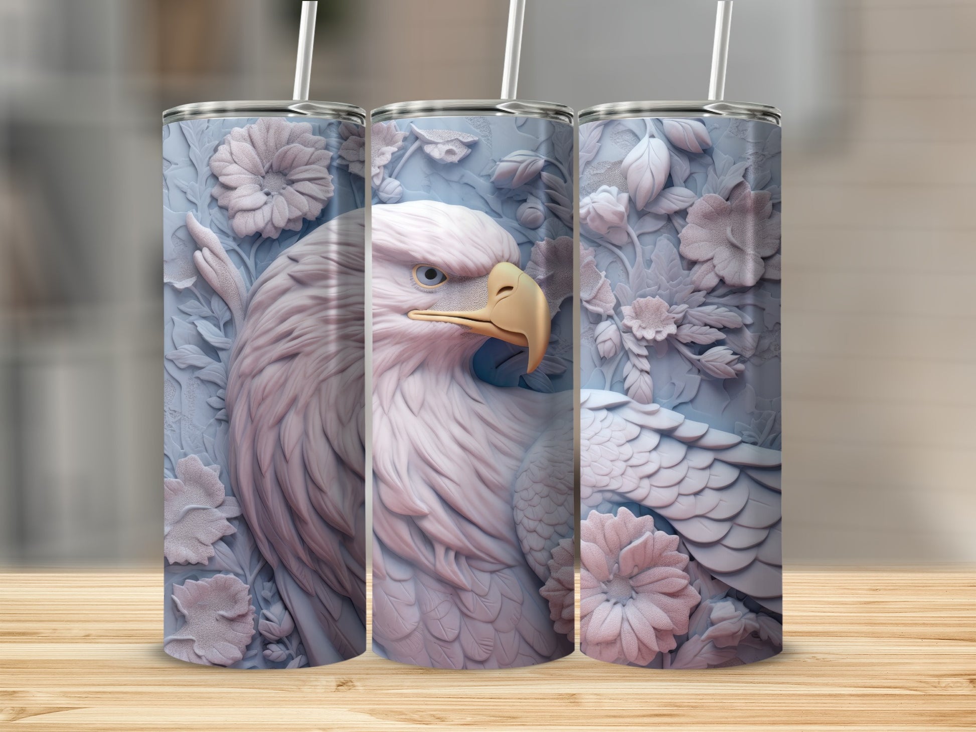 Three light blue tumblers featuring a detailed eagle and floral relief design.