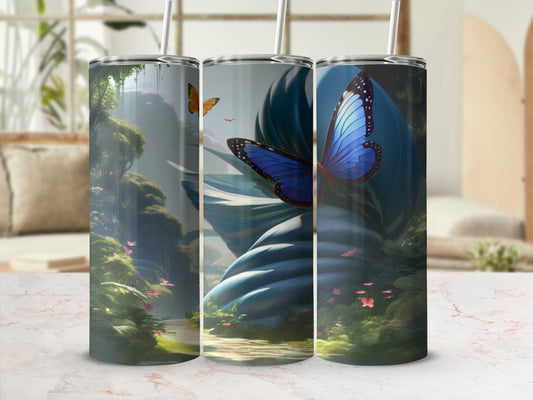 Tall tumbler with blue butterfly and forest scene on a marbled surface.