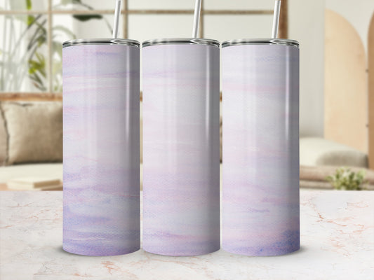 Three tall tumblers with a pastel watercolor design on a marbled surface.