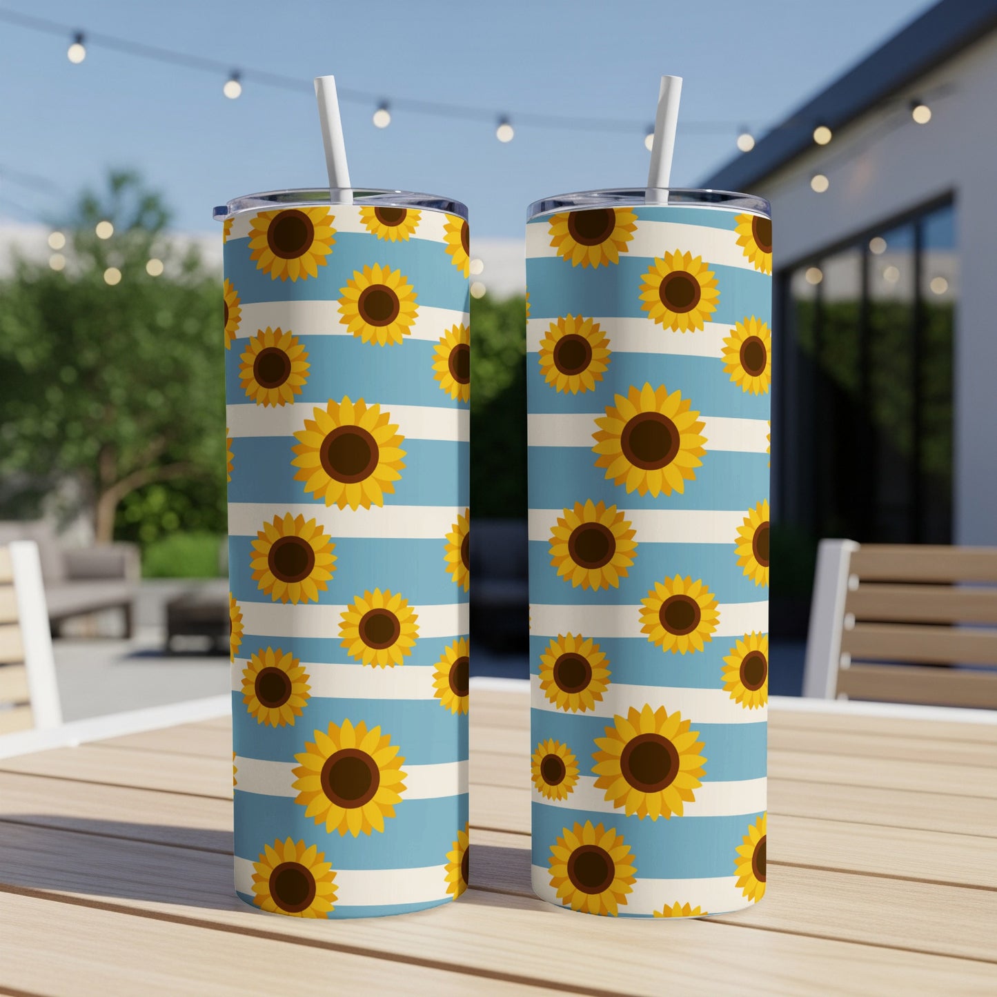 Two tumblers with sunflowers on a blue and white striped pattern.