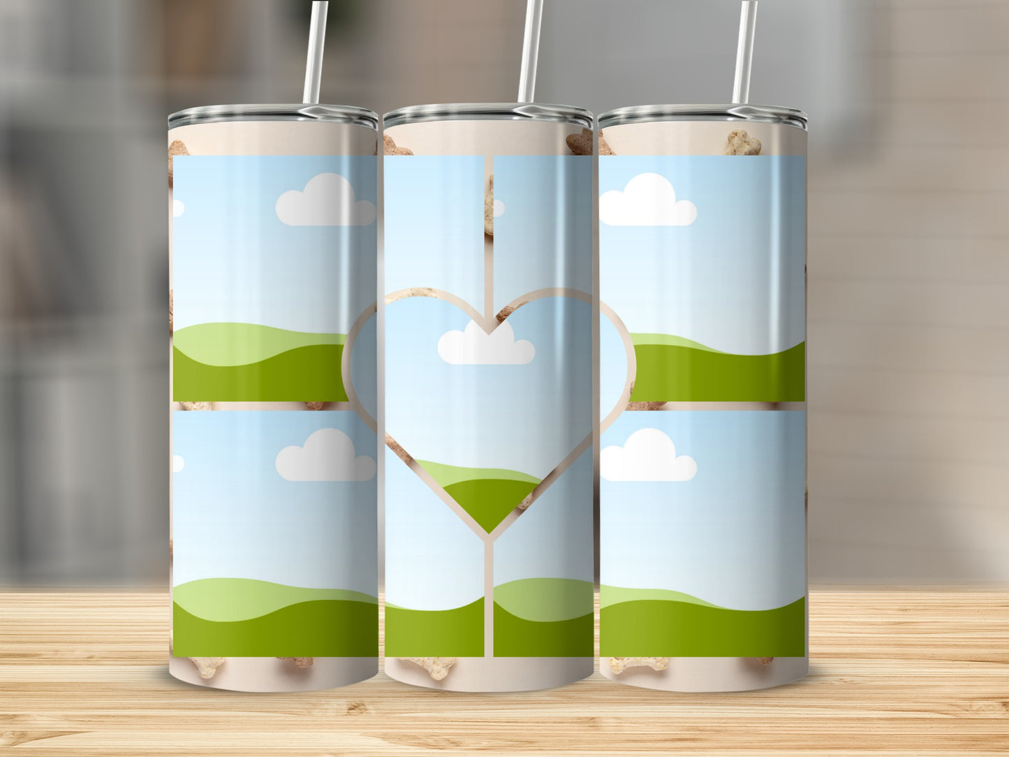 Three tumblers with a landscape design featuring a heart cutout in the center.