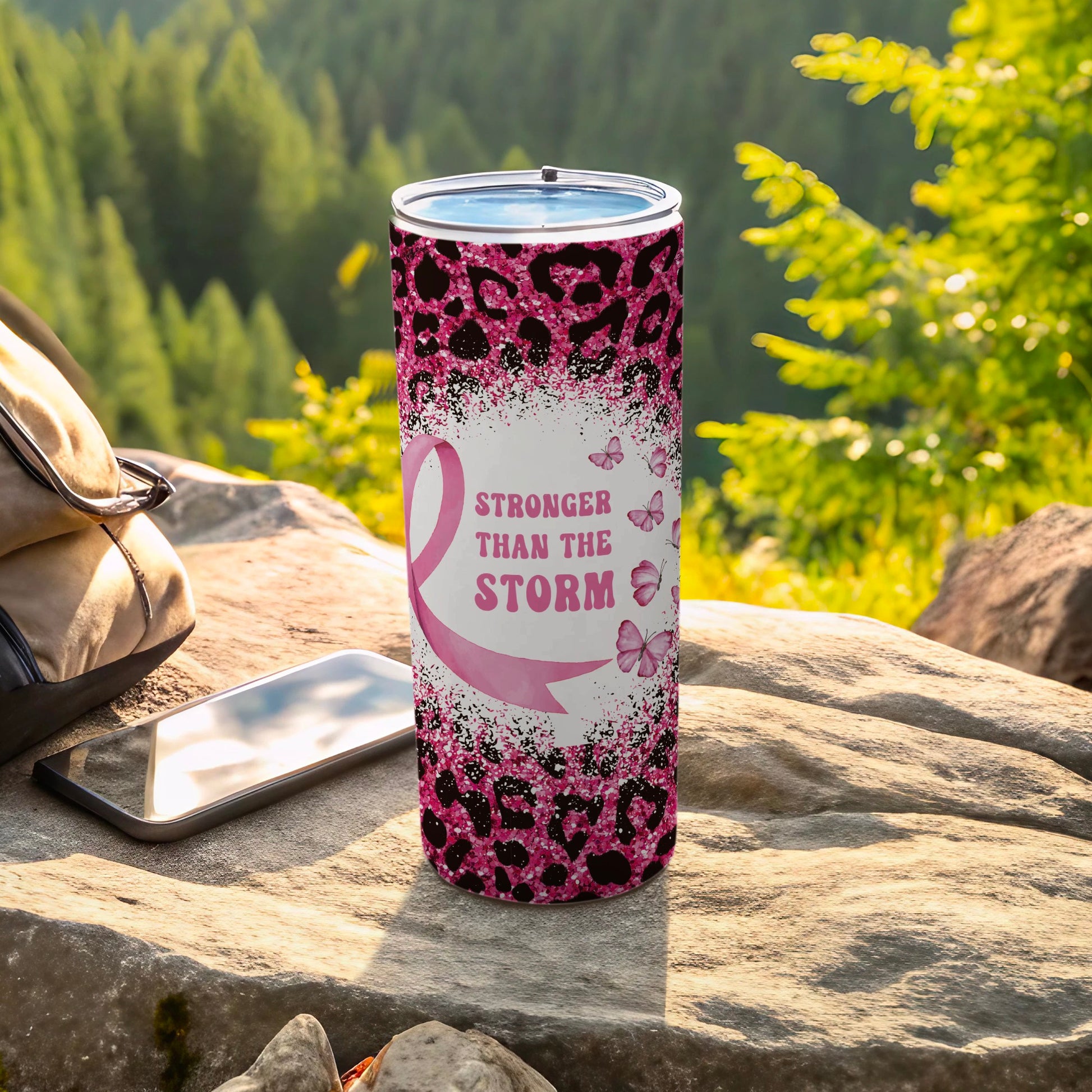 Tumbler with pink ribbon and butterflies, "Stronger Than the Storm" text.